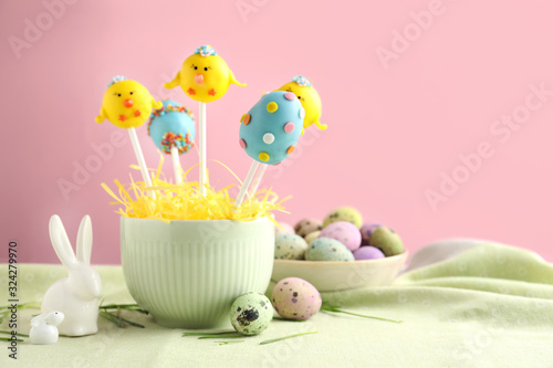 Delicious sweet cake pops on table  space for text. Easter holiday