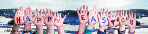 Children Hands Building Colorful Word Happy Easter. White Winter Landscape With Snow As Background