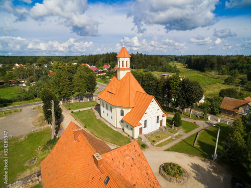 Aerial view of beautiful Saint Stanislaus Kostka Church in Pozezdrze, Poland (former Possessern, East Prussia) photo