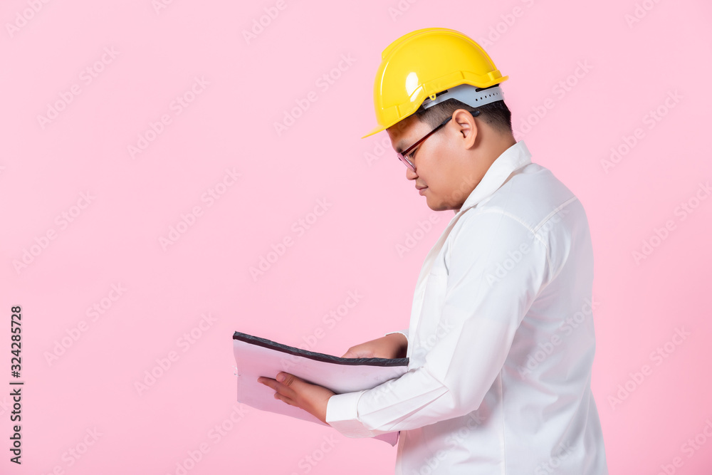 Industry worker or engineer working an architect builder studying layout plan serious civil engineer working with reading on blueprint isolated on pink blank copy space studio background,indoor studio Industry worker or engineer working an architect builder studying layout plan serious civil engineer working with reading on blueprint isolated on pink blank copy space studio background,indoor studio