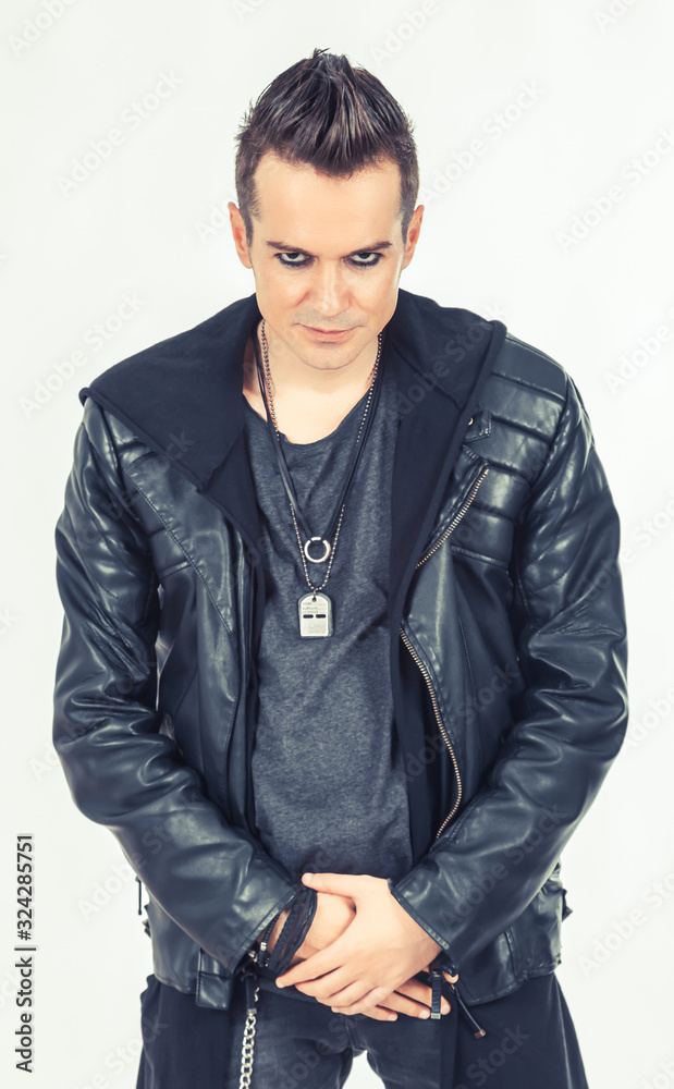 Portrait of confident hard rock performer on white background.
