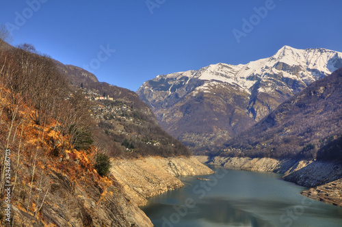 Alpine Lake and Snow-capped Mountain in Valley Verzasca in Ticino, Switzerland.