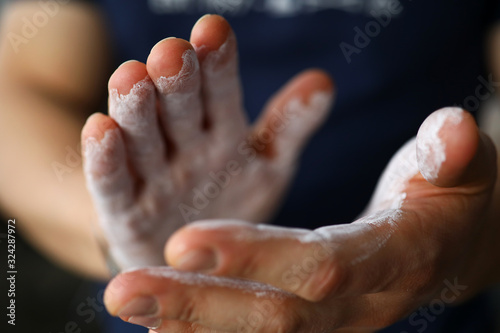 Male hands smeared with magnesium powder ready to workout