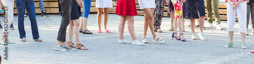 Social dance and flashmob concept - Fun and dance with in the summer on a city street. Close-up of dancers feet.