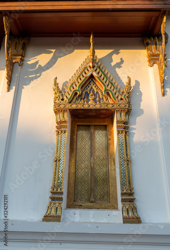 The window chapel (Ubosot) golden color and white building near the Amphawa floating market Samut Songkhram Thailand