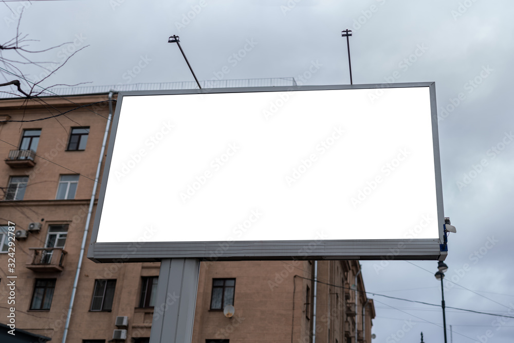 The billboard is large horizontal. Mockup with a white field in the afternoon. The billboard is large horizontal. Mockup with a white field in the afternoon.