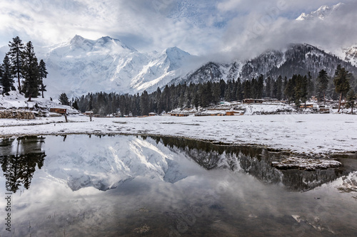 Nanga parbat mountain reflection in lake on Fairy meadows valley beautiful winter snowy landscape Karakoram Pakistan