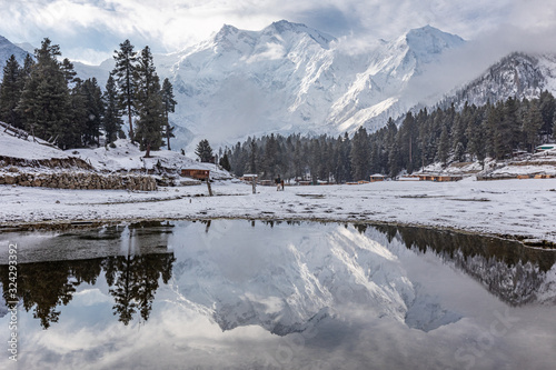 Nanga parbat mountain reflection in lake on Fairy meadows valley beautiful winter snowy landscape Karakoram Pakistan photo