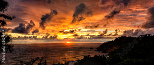 Fototapeta Naklejka Na Ścianę i Meble -  The coastline of the Pacific ocean at sunset in Manuel Antonio in Costa Rica made by different photos stitched together. 