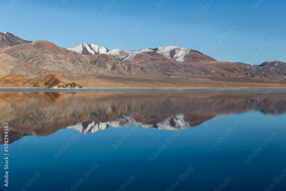 Mirror reflection in calm lake. morning light. Western Mongolia