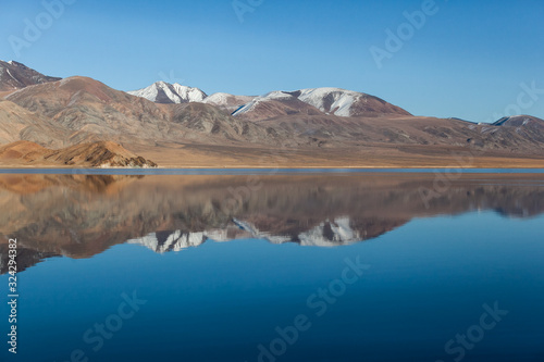 Mirror reflection in calm lake. morning light. Western Mongolia