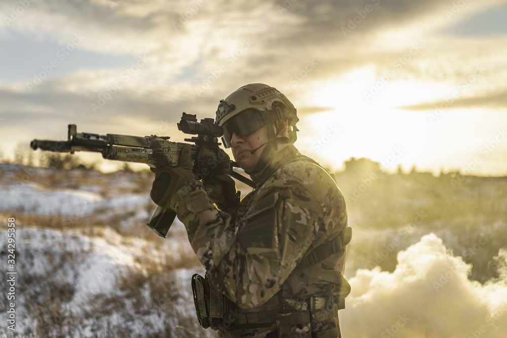 equipped army soldier Man in the winter khaki camouflage is patrolling or patrol field territory. commandos with full equipment helmet and gun watch battlefield. Modern army soldier equipped army soldier Man in the winter khaki camouflage is patrolling or patrol field territory. commandos with full equipment helmet and gun watch battlefield. Modern army soldier