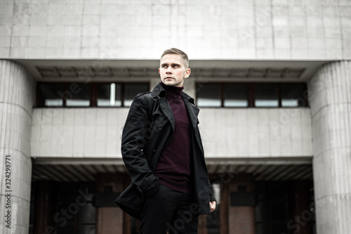 Stylish man in black trenchcoat