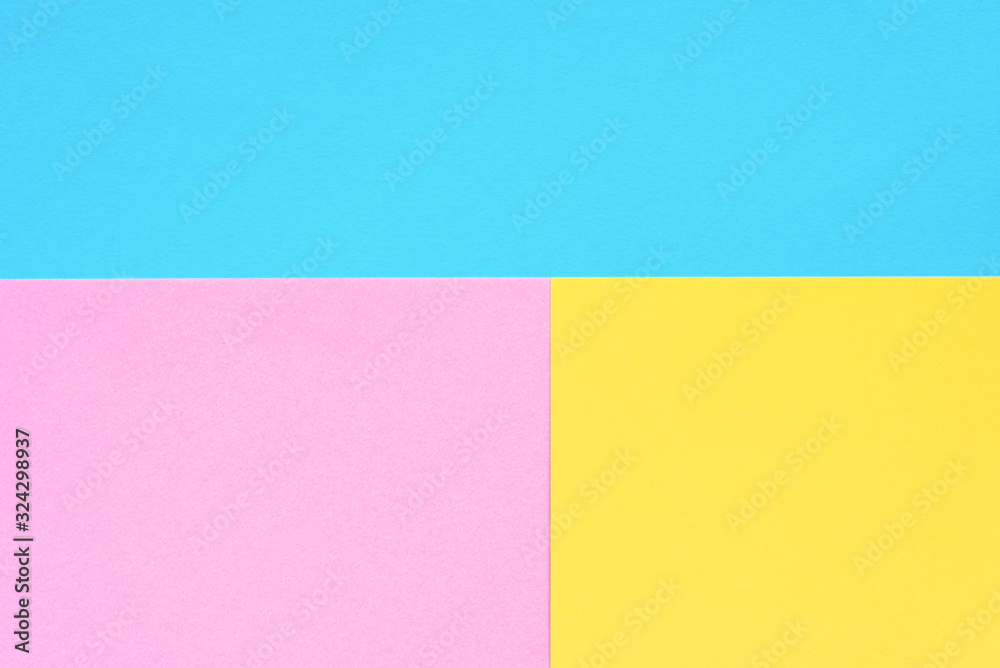 Blue, yellow and pink colored paper. Geometric empty paper background of three tones for copy space. Blue, yellow and pink colored paper. Geometric empty paper background of three tones for copy space.