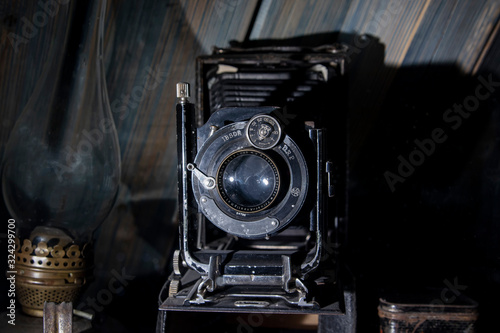 An old, folding, plate-shaped camera with a frame size of 9 × 12 cm. Central shutter