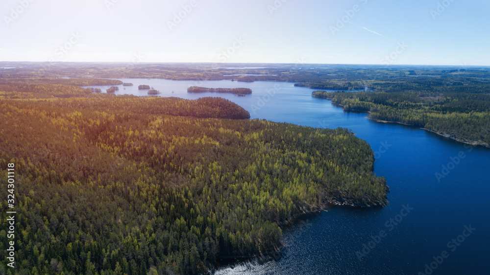 Aerial view over the huge lake and islands surrounded by forests Aerial view over the huge lake and islands surrounded by forests