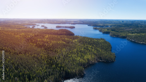 Aerial view over the huge lake and islands surrounded by forests