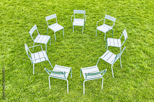 abstract picnic on grass circle of grey garden stools landscape from above against green lawn background. Aerial top down view of circle seating area with  seats for relax. City park rest zone