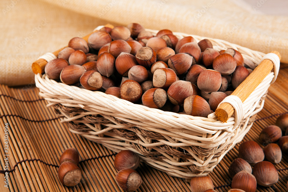 whole hazelnut kernels in a wicker basket still life whole hazelnut kernels in a wicker basket still life