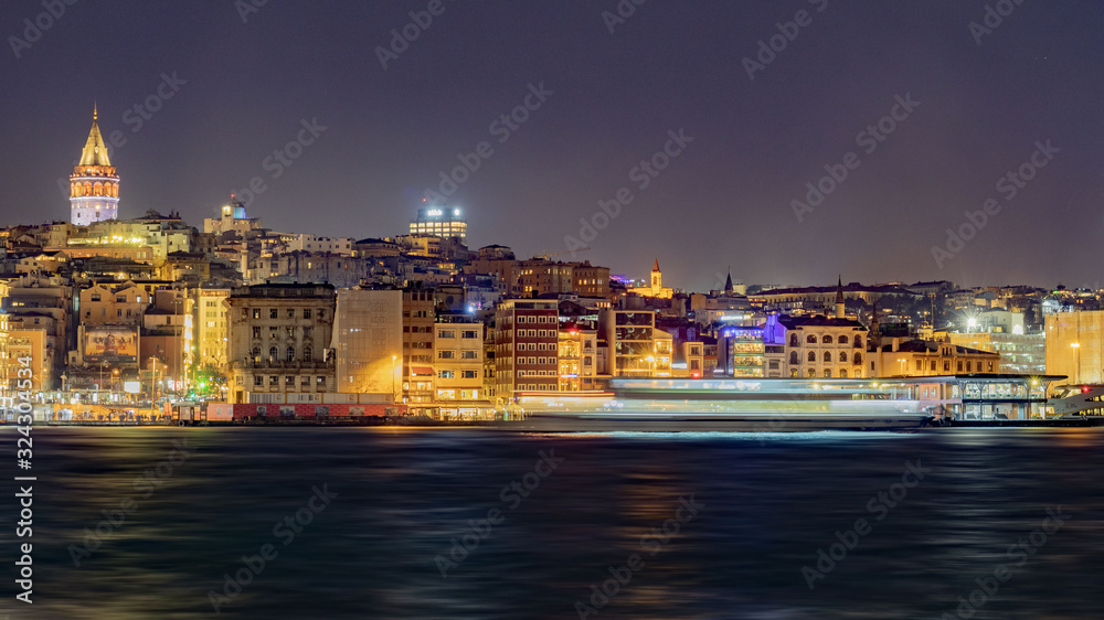 city lights illuminating Istanbul at night and a ship passing through the Golden Horn and Galata tower, long exposure, wavy estuary, street lights, high quality