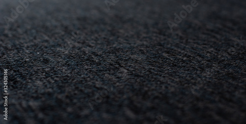 soft focus dark gray fabric textile material perspective textured background surface with blurred frame space