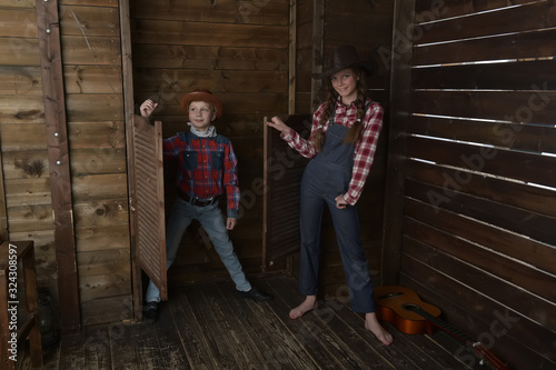 Fototapeta Naklejka Na Ścianę i Meble -  brother and sister in cowboy hats