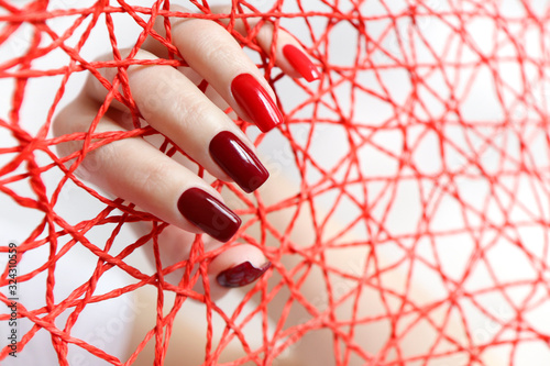 Fotografie, Obraz Fashionable red nail Polish color from light to dark on a rectangular shape