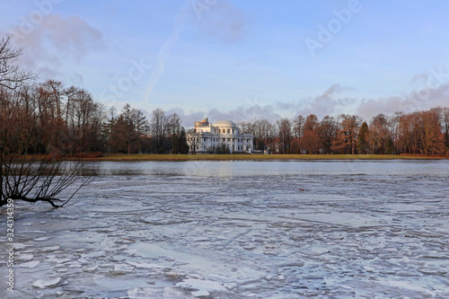 Winter view of Nevka River near Yelagin Island in St.Petersburg, Russia. Landscape with cold water, ice, trees and a building facade. photo