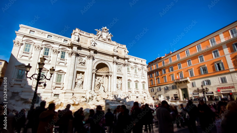 Fototapeta premium The marble facade of the Trevi Fountain illuminated by the sun