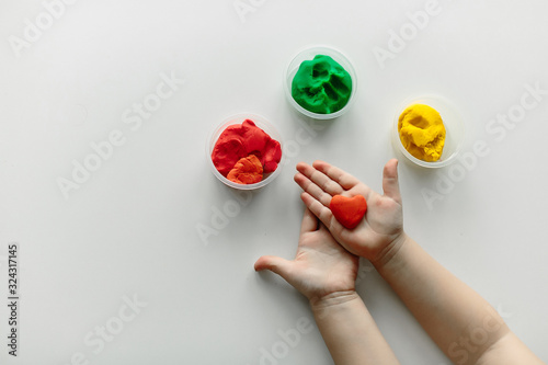 plasticine heart in the hands of a child