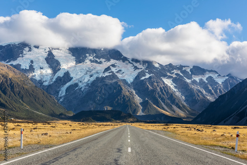 New Zealand, Oceania, South Island, Canterbury, Ben Ohau, Southern Alps (New Zealand Alps), Mount Cook National Park, Mount Cook Road and Aoraki / Mount Cook, Empty road in mountain landscape photo