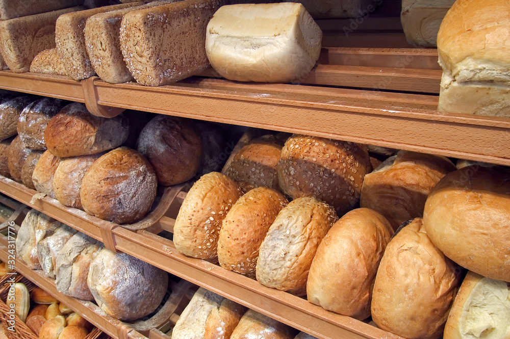 Shelves with loaves of freshly baked bread on display in bakery