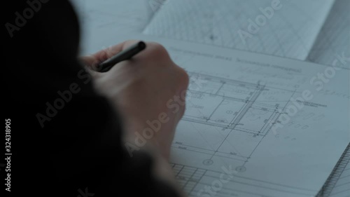 Papers and drawings on the desk in front of the engineer. Close up