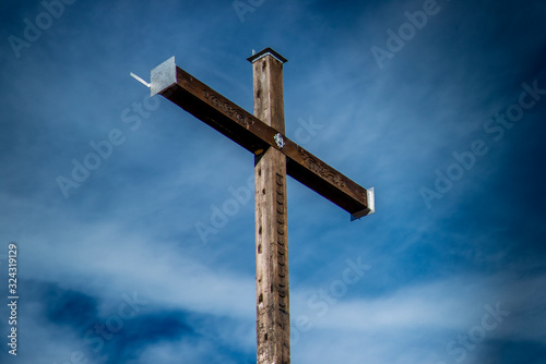 Austria, Allg_alps, summit cross on Hahnenkoepfle in front of blue sky photo