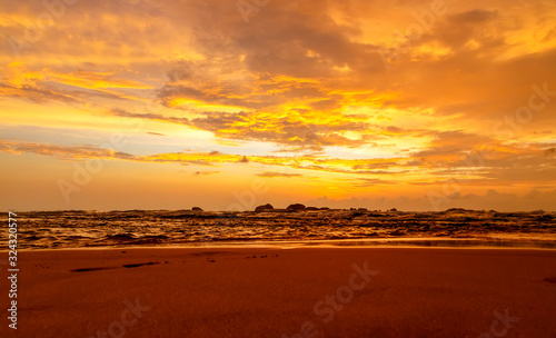 Dramatic sunset sky with red yellow clouds over ocean in Sri Lanka island