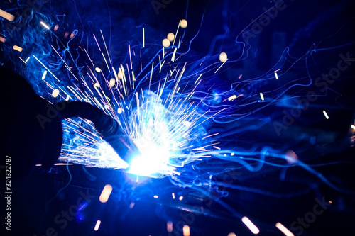 The process of welding metal in the dark with the formation of a large amount of smoke and sparks.