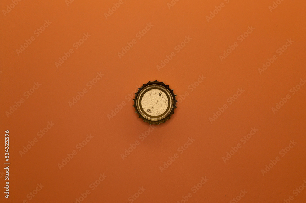 bottle cap on orange background bottle cap on orange background