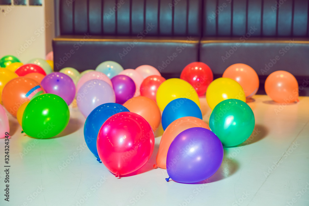 Flat lay of colorful balloons . holiday, children's party, a games room, a box filled with small colored balls . Different color balloons on the floor . Flat lay of colorful balloons . holiday, children's party, a games room, a box filled with small colored balls . Different color balloons on the floor .