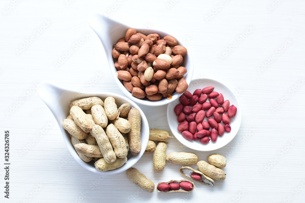 Dried peanuts (Arachis hypogaea) peanuts in shells, whole and chopped in containers