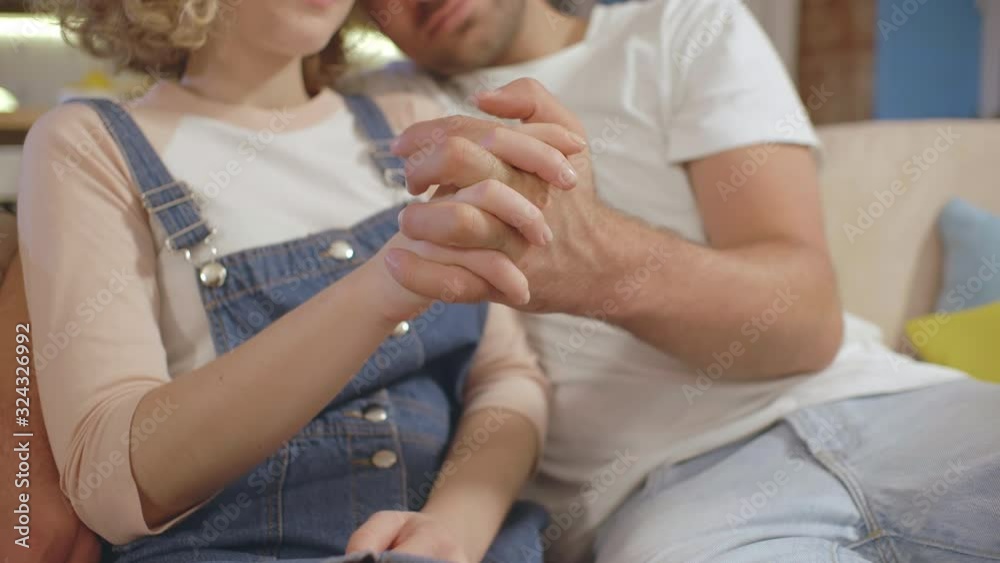 Happy young couple hold hands enjoying romantic moment Happy young couple hold hands enjoying romantic moment