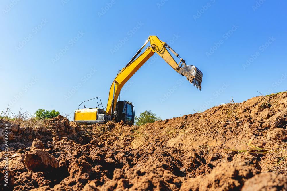 Backhoe digging up soil to prepare agricultural land. Backhoe digging up soil to prepare agricultural land.