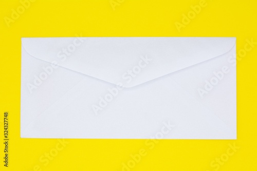 white envelope on yellow paper. - background.
