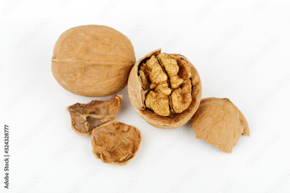 some cracked walnuts isolated on white background some cracked walnuts isolated on white background
