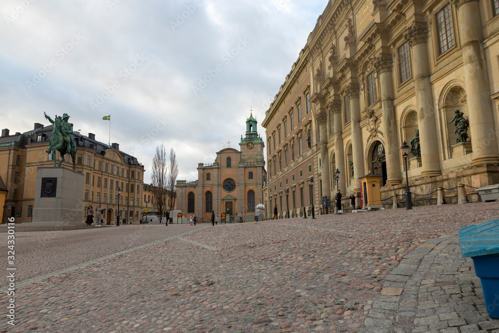 Street in front of the Stockholm Royal Palace - the official residence of the Swedish monarchs on the main promenade of the island of Stadholmen in the center of Stockholm.