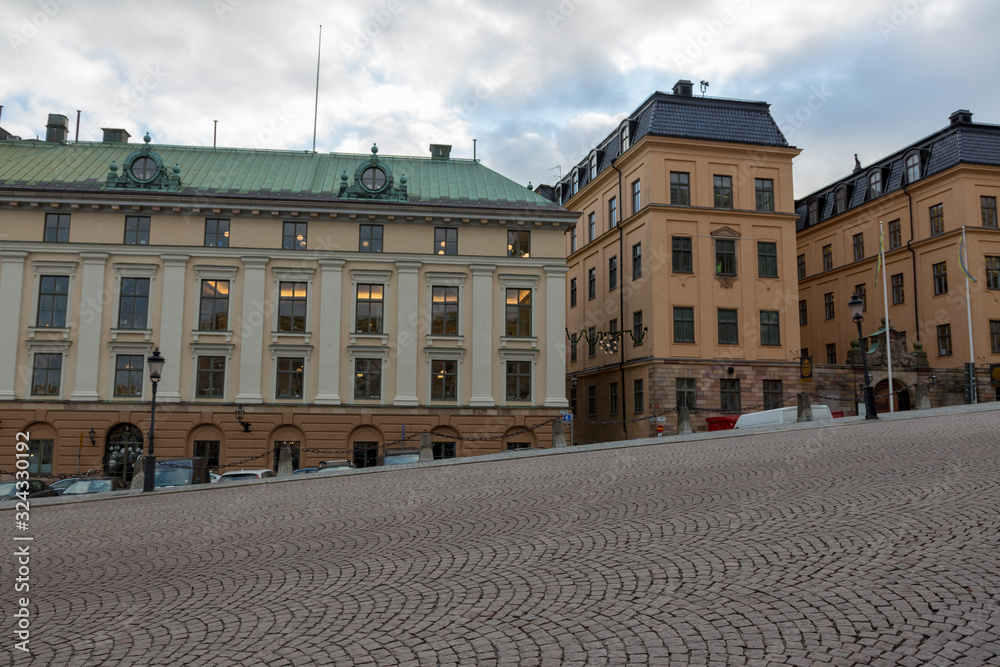 Street in front of the Stockholm Royal Palace - the official residence of the Swedish monarchs on the main promenade of the island of Stadholmen in the center of Stockholm.
