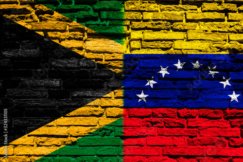 Flag of Jamaica and Venezuela on brick wall