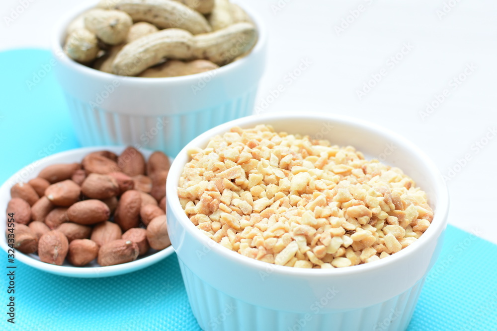 (Arachis hypogaea) chopped peanuts in containers (Arachis hypogaea) chopped peanuts in containers