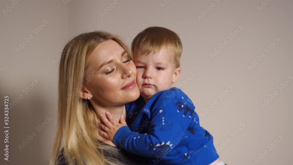 Blonde long hair hot glamour mother playing with her baby boy child at home spending quality family values time Blonde long hair hot glamour mother playing with her baby boy child at home spending quality family values time