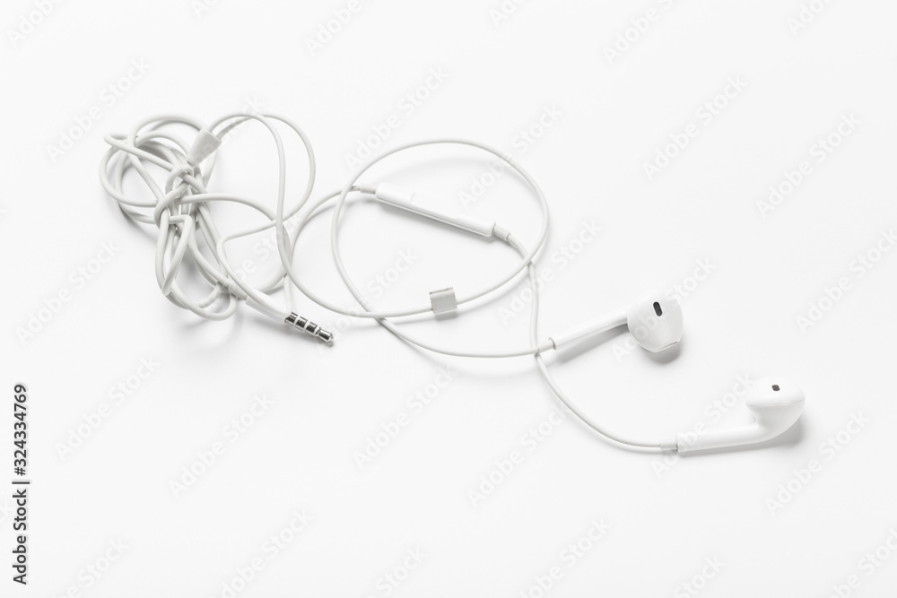 White modern headphones with a headset on a light gray background White modern headphones with a headset on a light gray background
