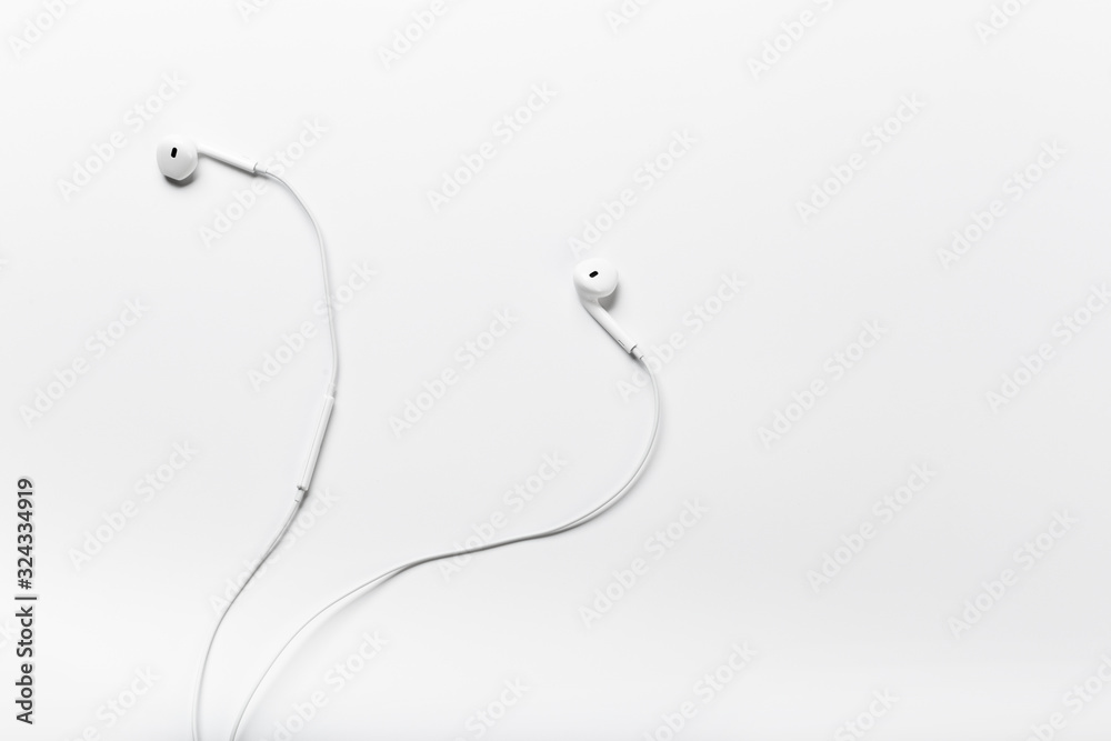 White modern headphones with a headset on a light gray background White modern headphones with a headset on a light gray background